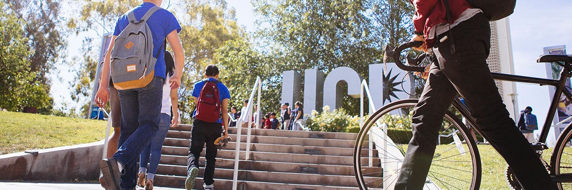 Students walk by the UCR letters sculpture on their way to class. 