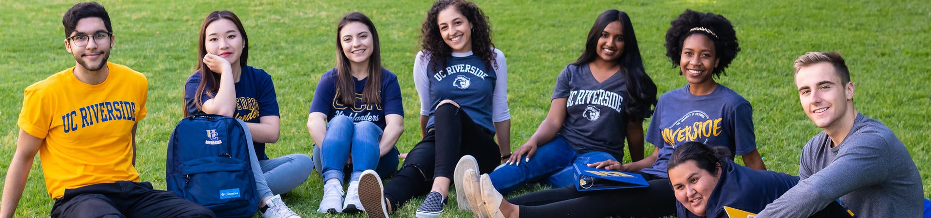 A group of UC Riverside students pose on one of the campus' lawns.