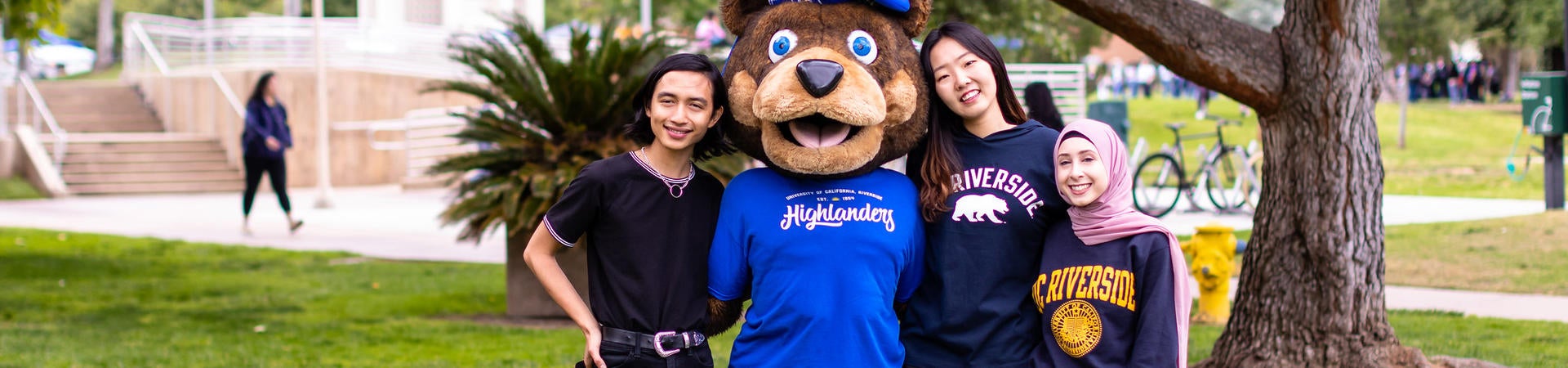 A group of UC Riverside students pose with the school's bear mascot, Scotty Highlander.